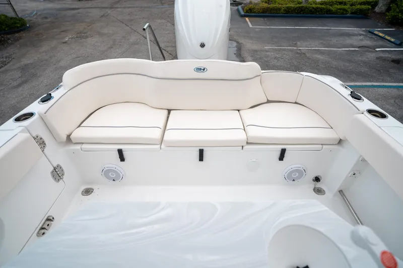 Slide: The Image of 2025 Sea Hunt Ultra 239 SE boat interior with white cushioned seating. - 13