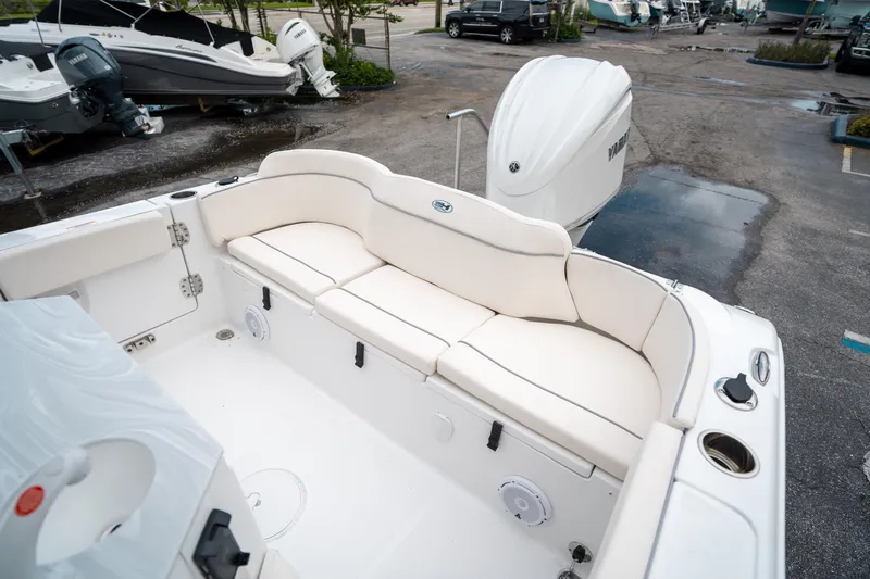 Slide: The Image of 2025 Sea Hunt Ultra 239 SE boat interior with white seating and Yamaha outboard motor. - 14