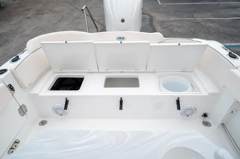 Slide: The Image of 2025 Sea Hunt Ultra 239 SE boat interior with storage compartments and speakers. - 17
