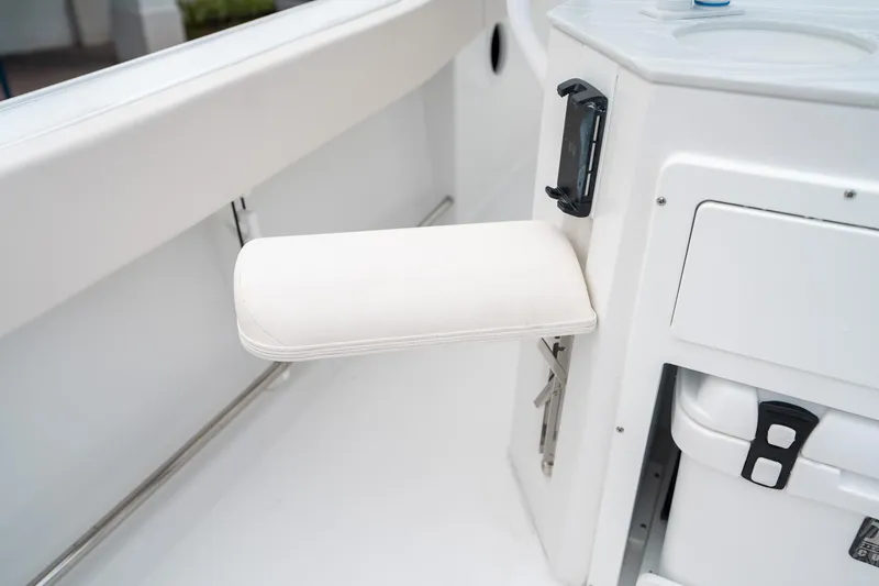 Slide: The Image of 2025 Sea Hunt Ultra 239 SE boat interior with foldable seat and storage compartment. - 19