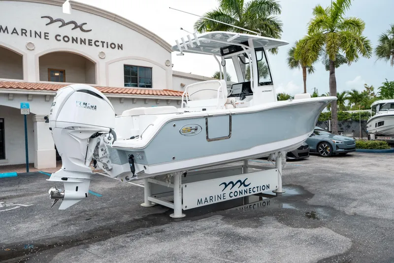 Slide: The Image of 2025 Sea Hunt Ultra 239 SE boat displayed at Marine Connection dealership. - 2