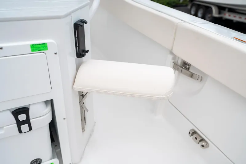 Slide: The Image of 2025 Sea Hunt Ultra 239 SE boat interior with foldable seat and storage compartment. - 20