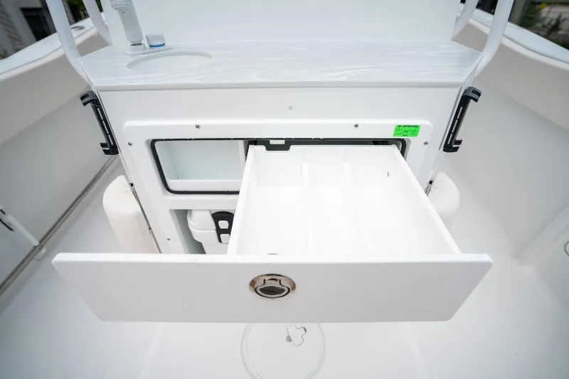 Slide: The Image of Storage compartment on 2025 Sea Hunt Ultra 239 SE boat, featuring an open drawer. - 21