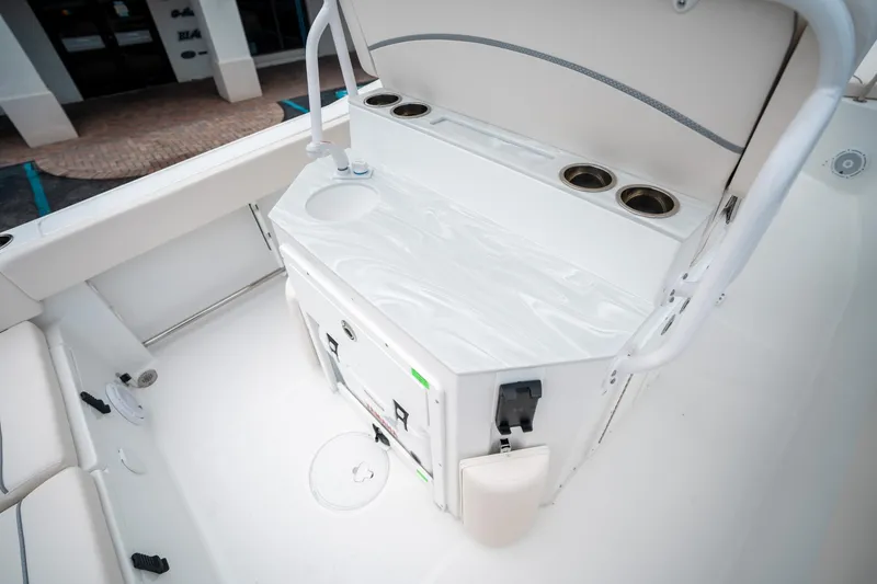 Slide: The Image of 2025 Sea Hunt Ultra 239 SE boat interior with storage and cup holders. - 24