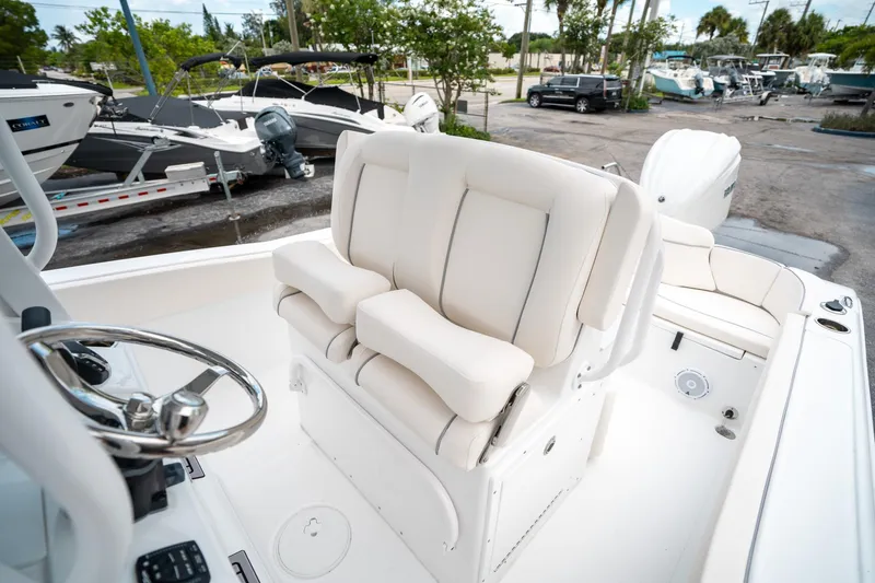 Slide: The Image of 2025 Sea Hunt Ultra 239 SE boat interior with plush seating and steering wheel. - 30