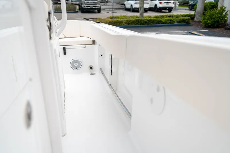 Slide: The Image of 2025 Sea Hunt Ultra 239 SE boat interior, featuring white seating and speaker system. - 34