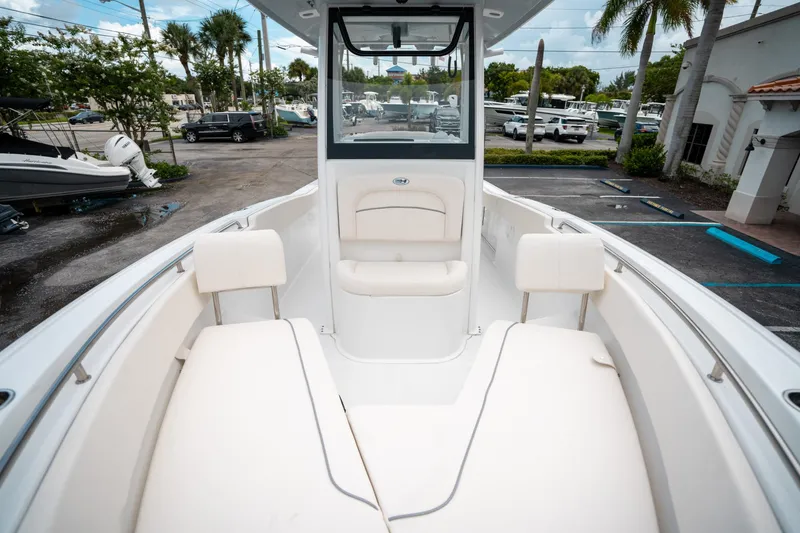 Slide: The Image of 2025 Sea Hunt Ultra 239 SE boat interior with white seating and console. - 40