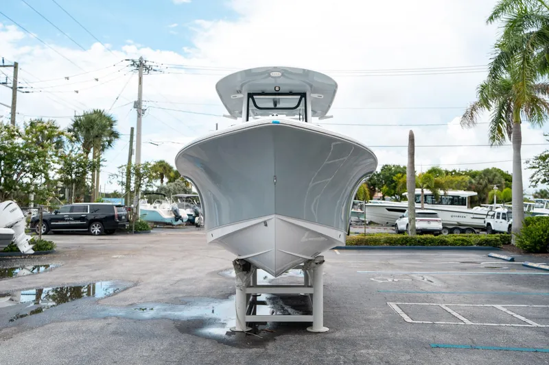 Slide: The Image of 2025 Sea Hunt Ultra 239 SE boat displayed in a parking lot, front view. - 7