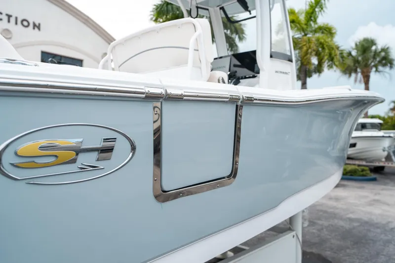 Slide: The Image of 2025 Sea Hunt Ultra 239 SE boat side view with logo, featuring sleek design. - 9