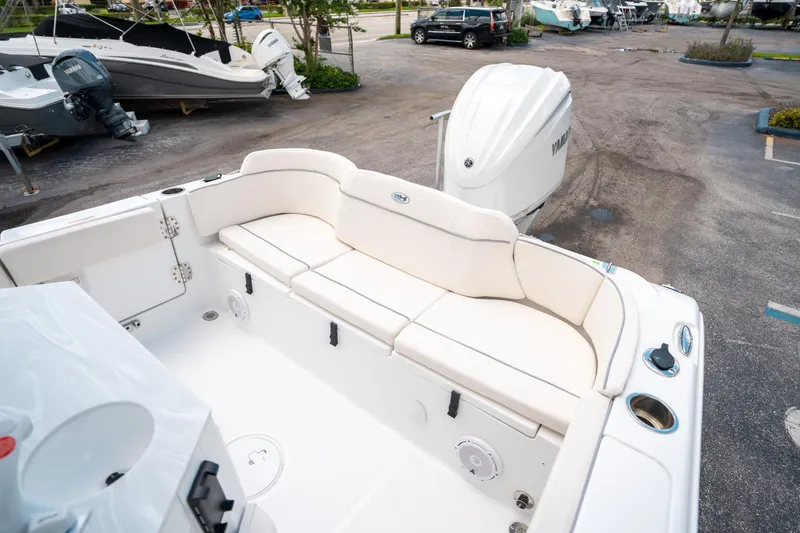 Slide: The Image of 2025 Sea Hunt Ultra 239 SE boat interior with white seating and Yamaha outboard motor. - 11