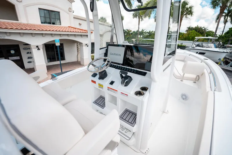 Slide: The Image of 2025 Sea Hunt Ultra 239 SE boat cockpit with Garmin navigation system and steering wheel. - 21
