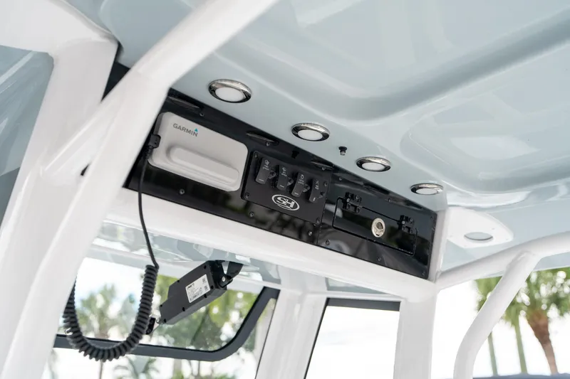 Slide: The Image of 2025 Sea Hunt Ultra 239 SE boat console with Garmin electronics and control panel. - 26