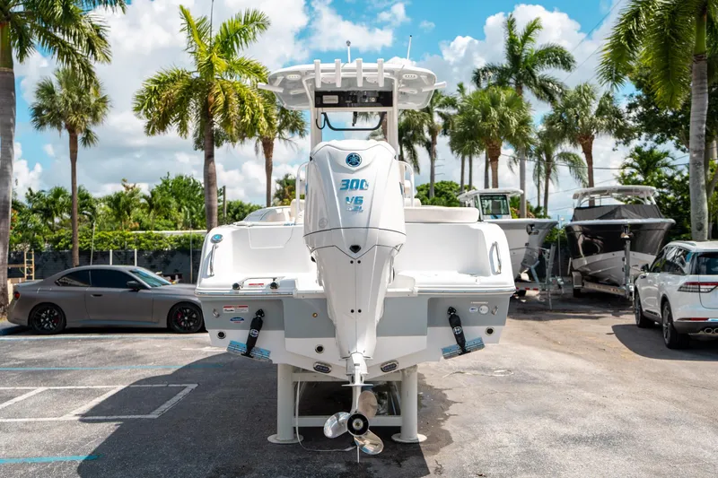 Slide: The Image of 2025 Sea Hunt Ultra 239 SE boat parked with palm trees in the background. - 3
