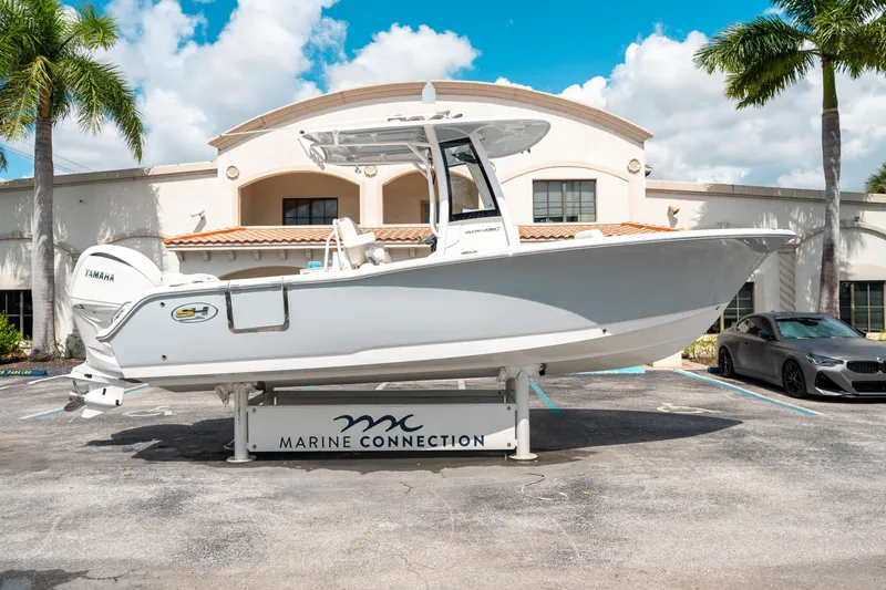 Slide: The Image of 2025 Sea Hunt Ultra 239 SE boat displayed at Marine Connection dealership. - 1