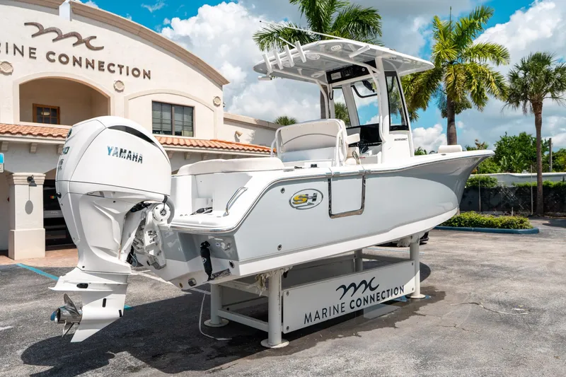 Slide: The Image of 2025 Sea Hunt Ultra 239 SE boat displayed at Marine Connection dealership. - 2