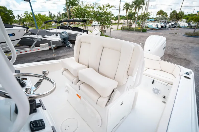 Slide: The Image of 2025 Sea Hunt Ultra 239 SE boat interior with plush seating and steering wheel. - 27