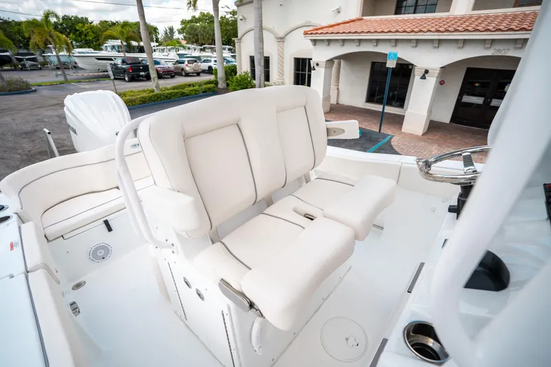 Slide: The Image of 2025 Sea Hunt Ultra 239 SE boat interior with white seating and steering wheel. - 29