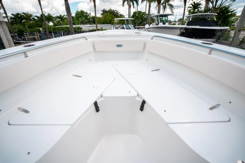 Slide: The Image of 2025 Sea Hunt Ultra 239 SE boat interior with spacious seating and storage compartments. - 43