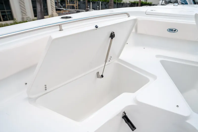 Slide: The Image of Open storage compartment on 2025 Sea Hunt Ultra 239 SE boat. - 45
