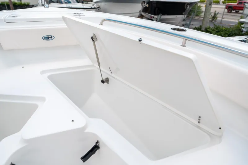 Slide: The Image of 2025 Sea Hunt Ultra 239 SE boat storage compartment open, showcasing spacious interior. - 46
