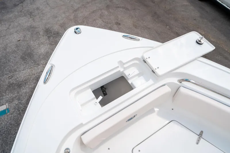 Slide: The Image of 2025 Sea Hunt Ultra 239 SE boat deck with storage compartment open. - 47