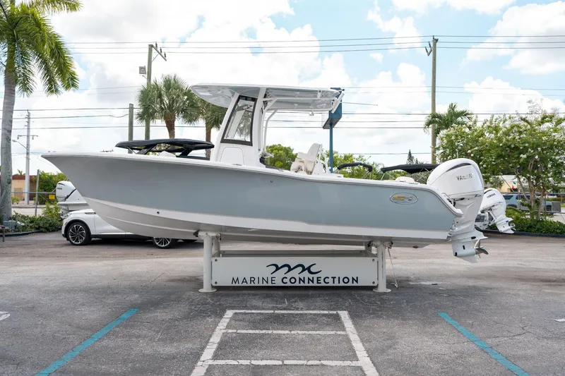 Slide: The Image of 2025 Sea Hunt Ultra 239 SE boat displayed at Marine Connection dealership. - 5