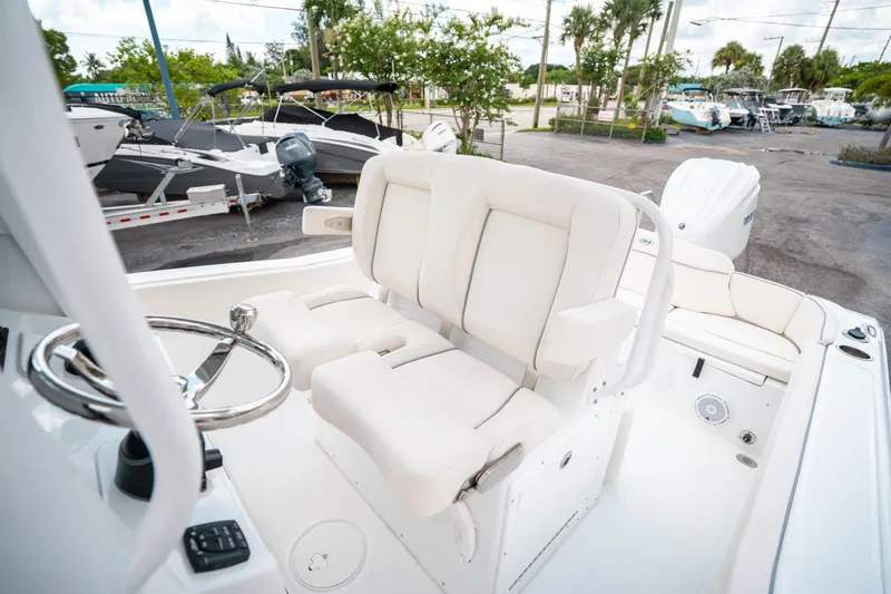 Slide: The Image of 2025 Sea Hunt Ultra 239 SE boat interior with white seating and steering wheel. - 30