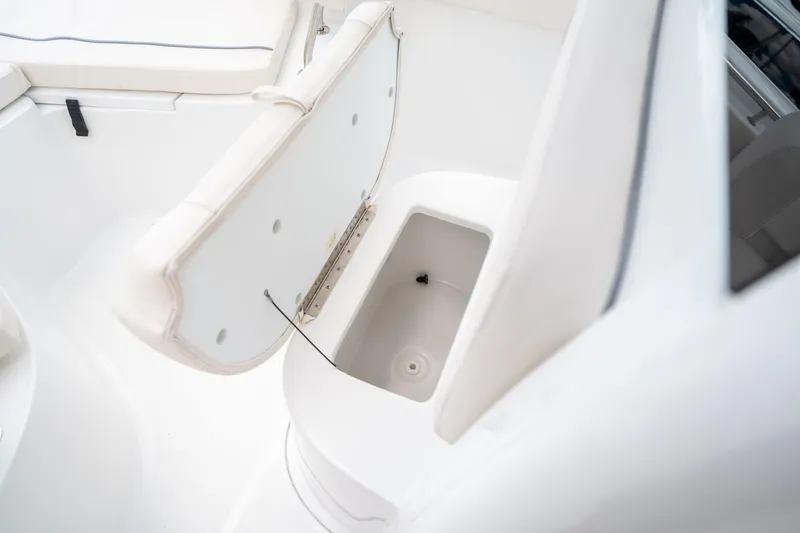 Slide: The Image of 2025 Sea Hunt Ultra 239 SE boat storage compartment with open lid. - 40