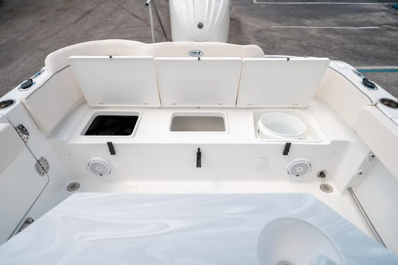 Slide: The Image of 2025 Sea Hunt Ultra 239 SE boat interior with storage compartments and speakers. - 14