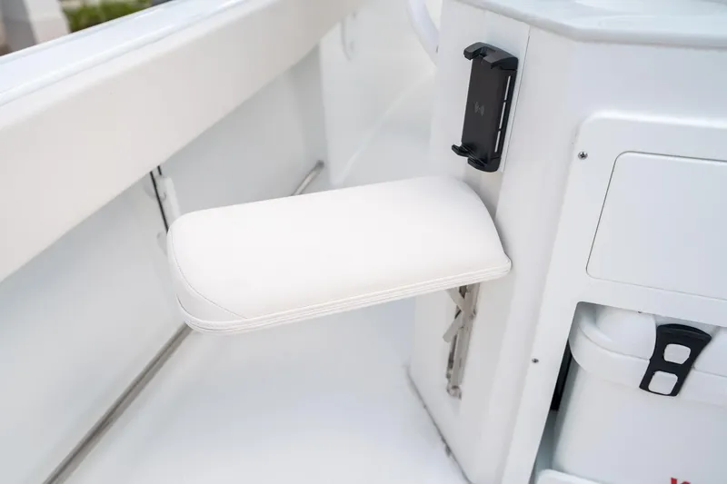 Slide: The Image of 2025 Sea Hunt Ultra 239 SE boat interior with white cushioned armrest. - 18