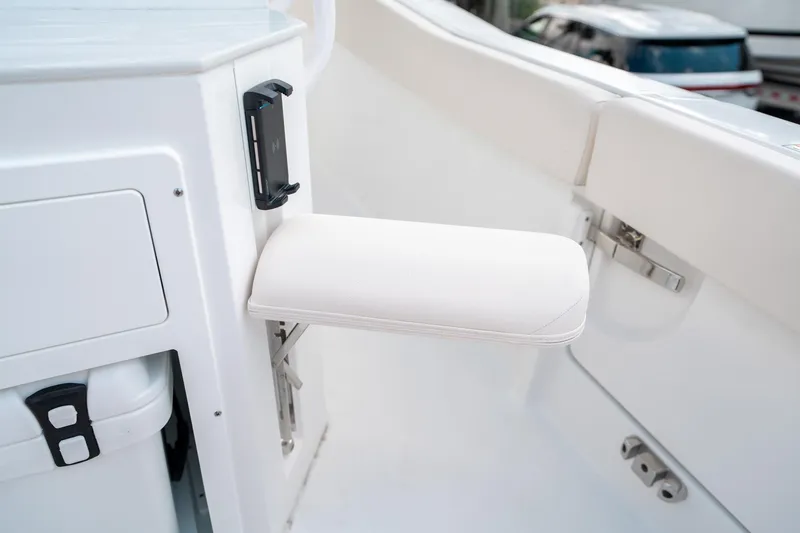 Slide: The Image of 2025 Sea Hunt Ultra 239 SE boat interior with white cushioned armrest detail. - 19