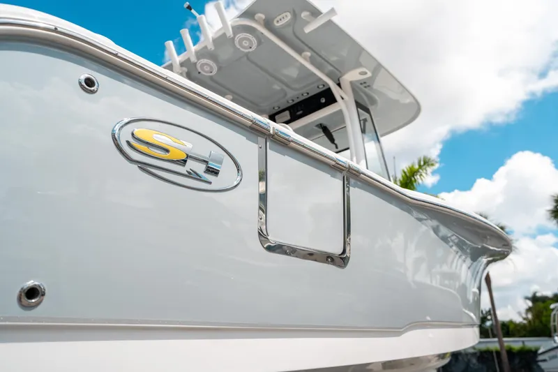 Slide: The Image of 2025 Sea Hunt Ultra 239 SE boat, close-up view, sleek design, sunny day. - 9