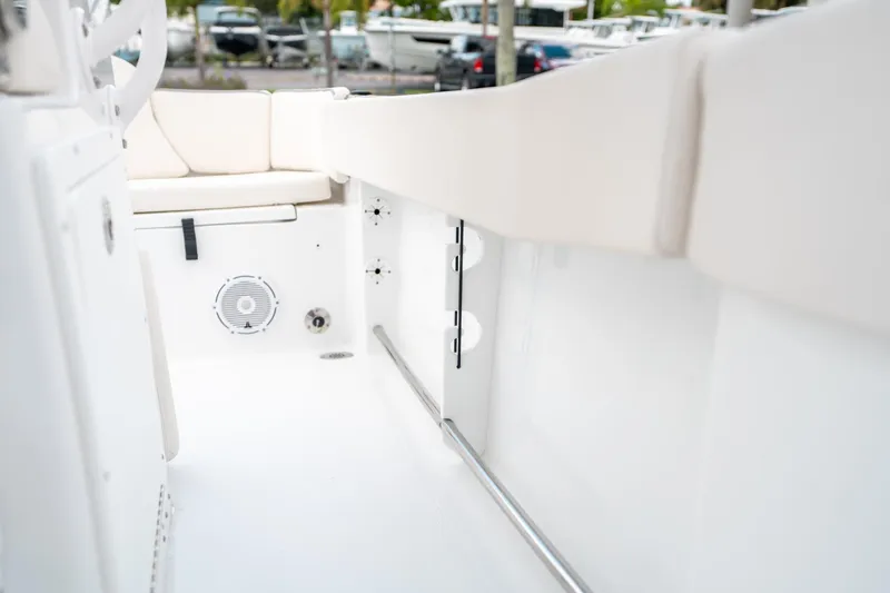 Slide: The Image of 2025 Sea Hunt Ultra 239 SE boat interior with white seating and speaker. - 31