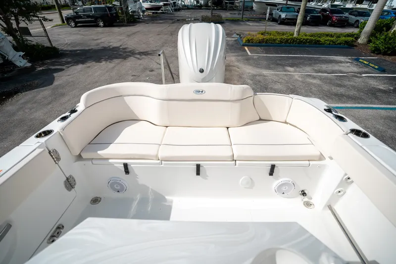 Slide: The Image of 2025 Sea Hunt Ultra 239 SE boat interior with white cushioned seating. - 10