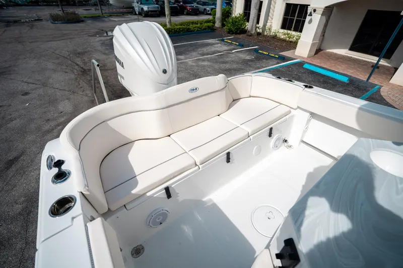 Slide: The Image of 2025 Sea Hunt Ultra 239 SE boat interior with white seating and Yamaha engine. - 12
