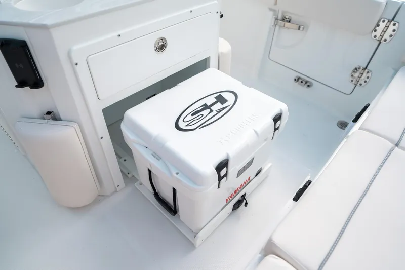 Slide: The Image of 2025 Sea Hunt Ultra 239 SE boat interior with a white cooler. - 20