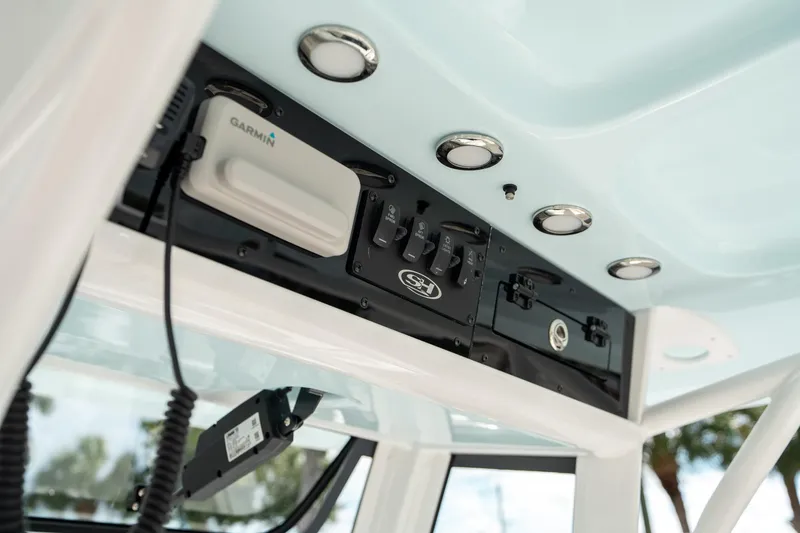 Slide: The Image of 2025 Sea Hunt Ultra 239 SE boat console with Garmin electronics and control switches. - 30