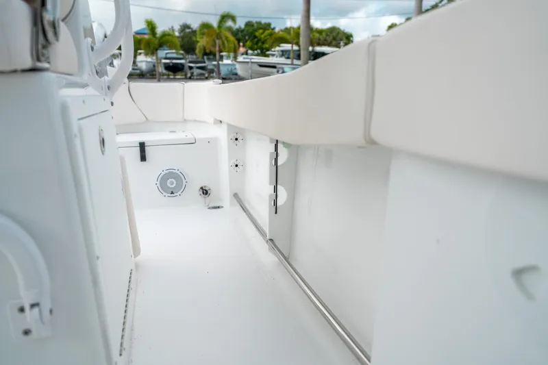 Slide: The Image of 2025 Sea Hunt Ultra 239 SE boat interior, featuring sleek white design and modern amenities. - 33
