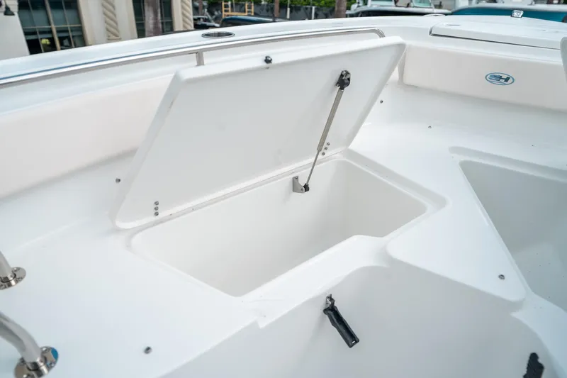 Slide: The Image of 2025 Sea Hunt Ultra 239 SE boat storage compartment open on deck. - 43