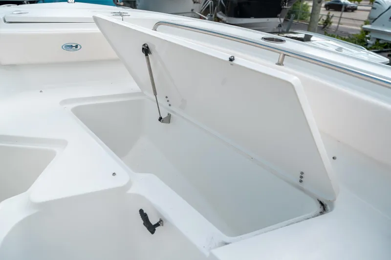 Slide: The Image of Open storage compartment on 2025 Sea Hunt Ultra 239 SE boat. - 44