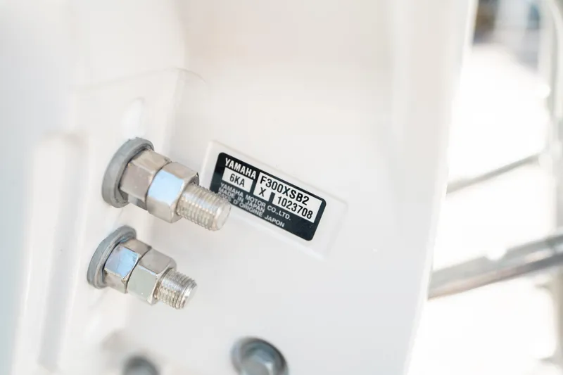 Slide: The Image of Close-up of Yamaha engine bolts on a 2025 Sea Hunt Ultra 239 SE boat. - 49