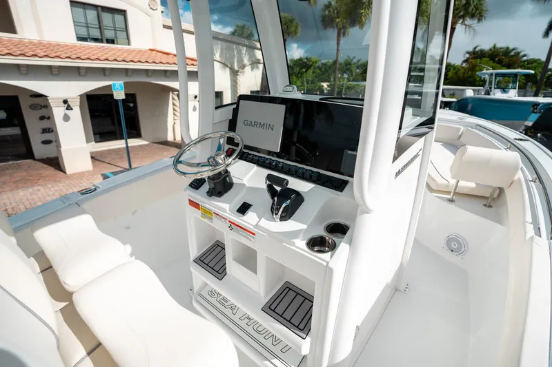 Slide: The Image of 2025 Sea Hunt Ultra 239 SE boat console with Garmin display and steering wheel. - 25