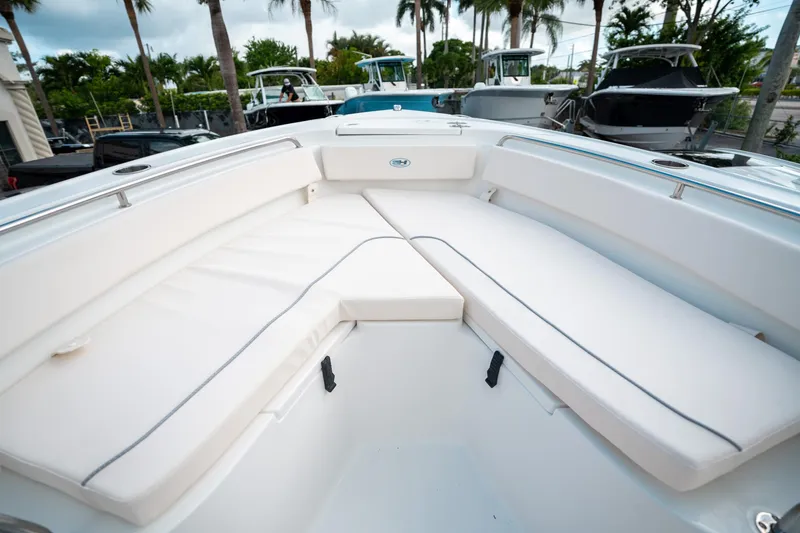 Slide: The Image of 2025 Sea Hunt Ultra 239 SE boat interior with white cushioned seating. - 36