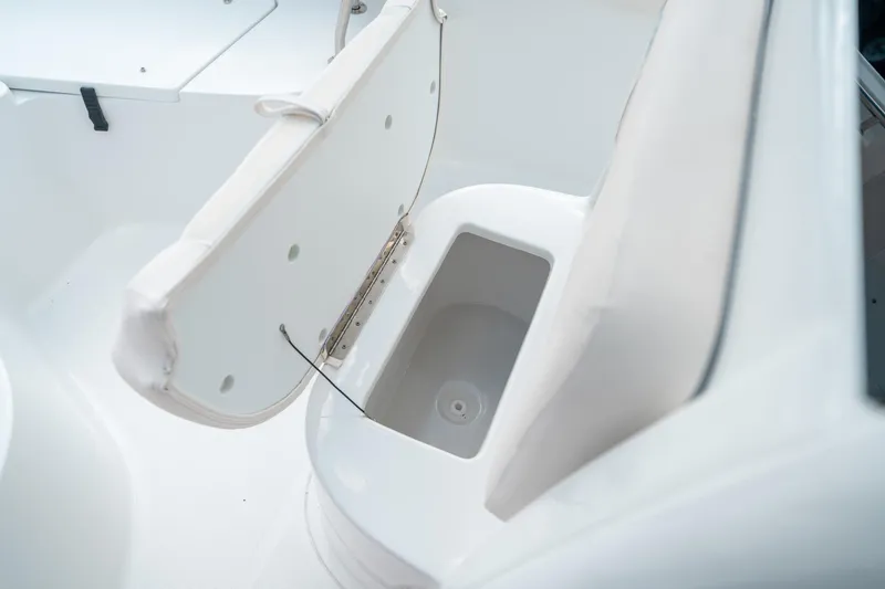 Slide: The Image of 2025 Sea Hunt Ultra 239 SE boat storage compartment with open lid. - 46