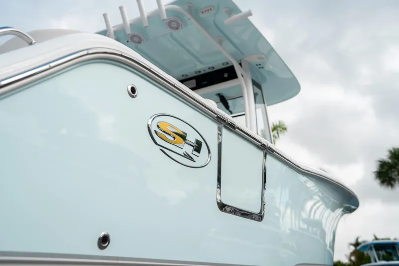 Slide: The Image of 2025 Sea Hunt Ultra 239 SE boat, close-up of sleek design and logo. - 9