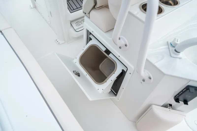 Slide: The Image of 2025 Sea Hunt Ultra 239 SE boat interior with open storage compartment. - 22