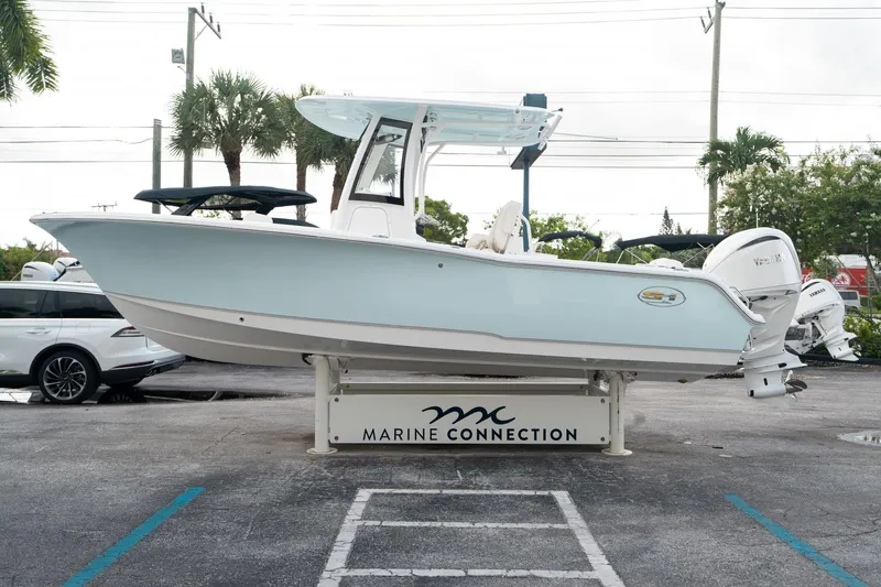 Slide: The Image of 2025 Sea Hunt Ultra 239 SE boat displayed at Marine Connection dealership. - 5