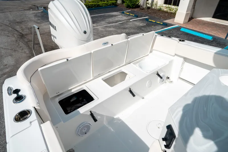 Slide: The Image of 2025 Sea Hunt Ultra 239 SE boat interior with storage compartments and Yamaha engine. - 16