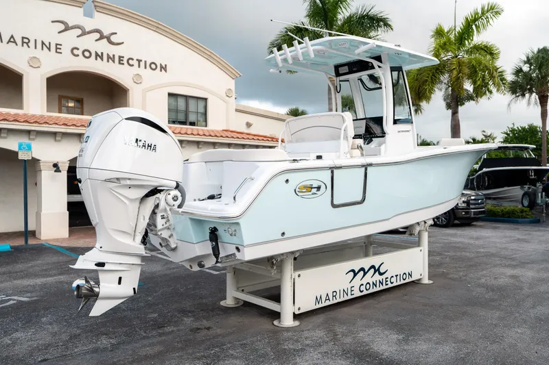 Slide: The Image of 2025 Sea Hunt Ultra 239 SE boat displayed at Marine Connection dealership. - 2
