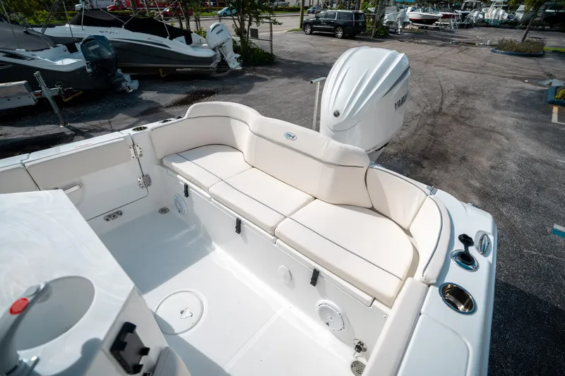 Slide: The Image of 2025 Sea Hunt Ultra 239 SE boat interior with white seating and Yamaha outboard motor. - 11